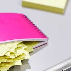 Notebook and sticky notes on a table